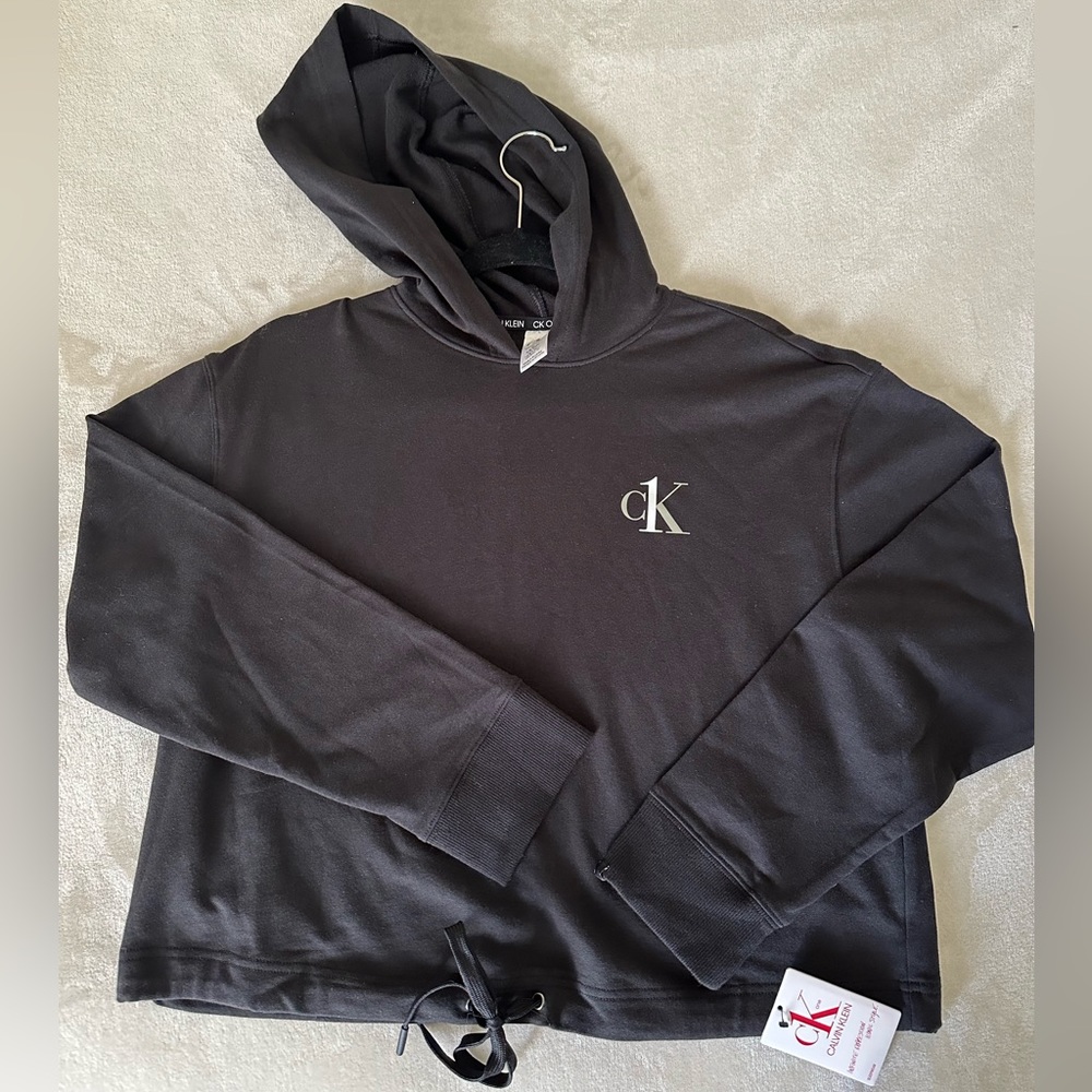 Calvin Klein cropped workout long sleeve with hood. Never worn, tag still on.